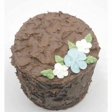 Top view of a chocolate cake covered in chocolate frosting and decorated with royal icing flowers