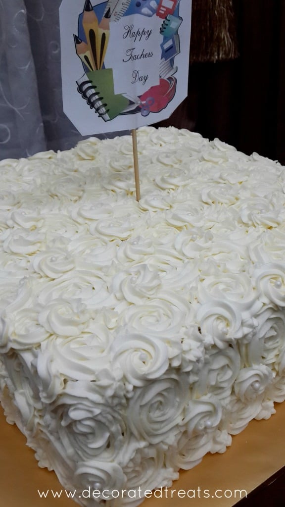 White buttercream rosettes on a cake