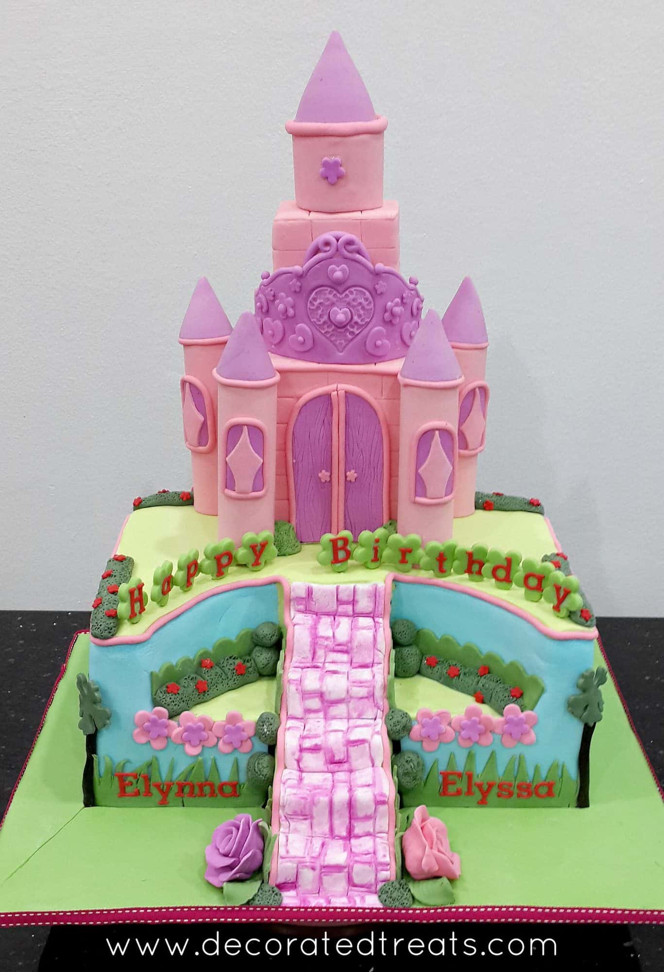 A rectangle cake with a pink castle cake topper
