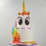 A two tier unicorn came with rainbow colored floral mane and large eyes.