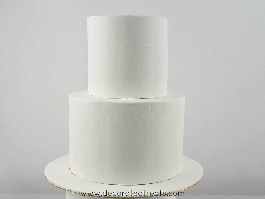2 tier cake covered in plain white fondant