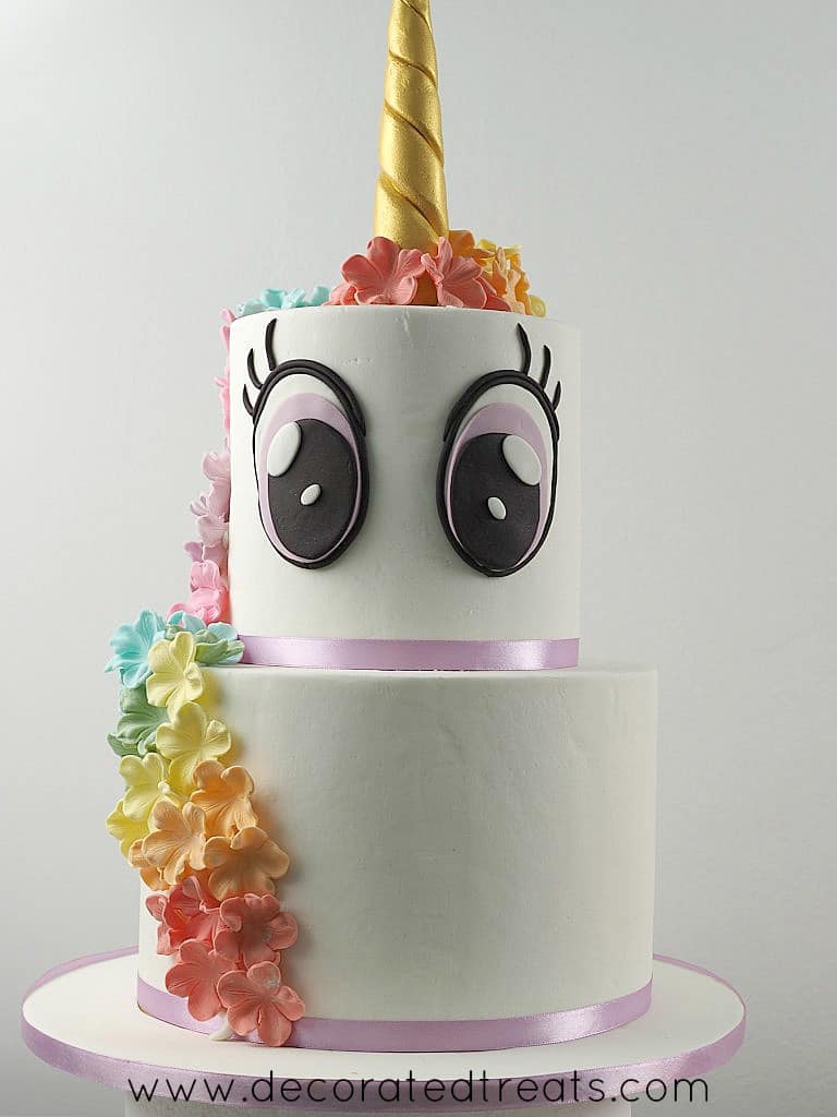 A two tier unicorn came with rainbow colored floral mane and large eyes