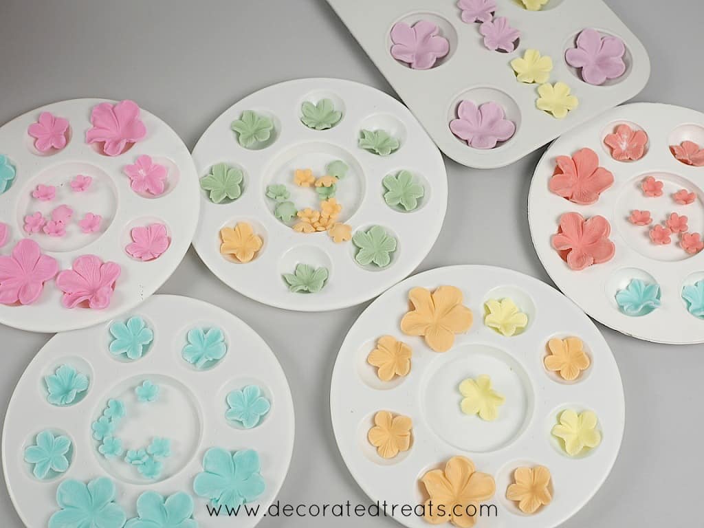 Rainbow colored fondant flowers in flower formers