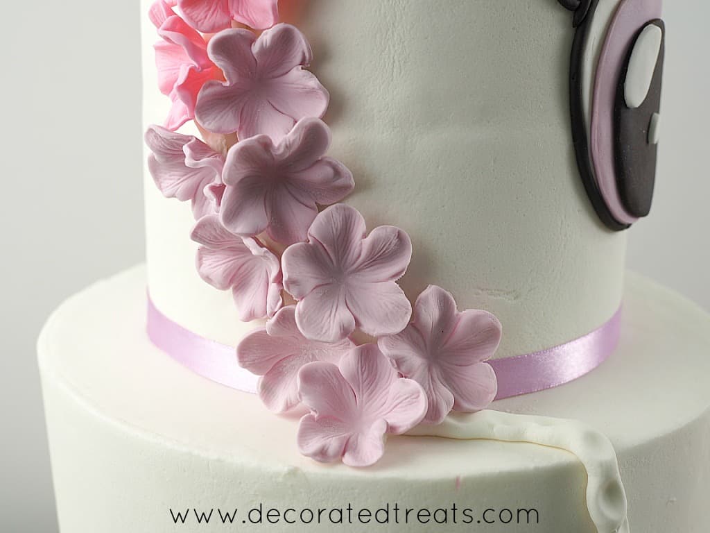 Purple flowers on a unicorn birthday cake