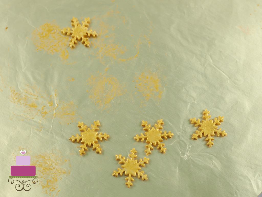 Gold snowflakes on a gold cake board