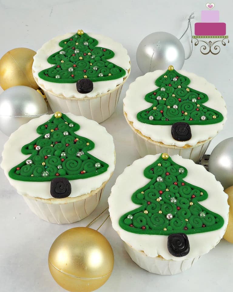 4 cupcakes with 2d Christmas tree decoration.