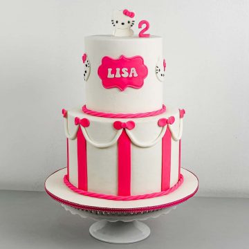 A white and pink 2 tier Hello Kitty Birthday cake