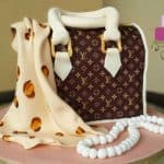 A Louis Vuitton inspired handbag cake with a leopard print scarf and edible pearl necklace.