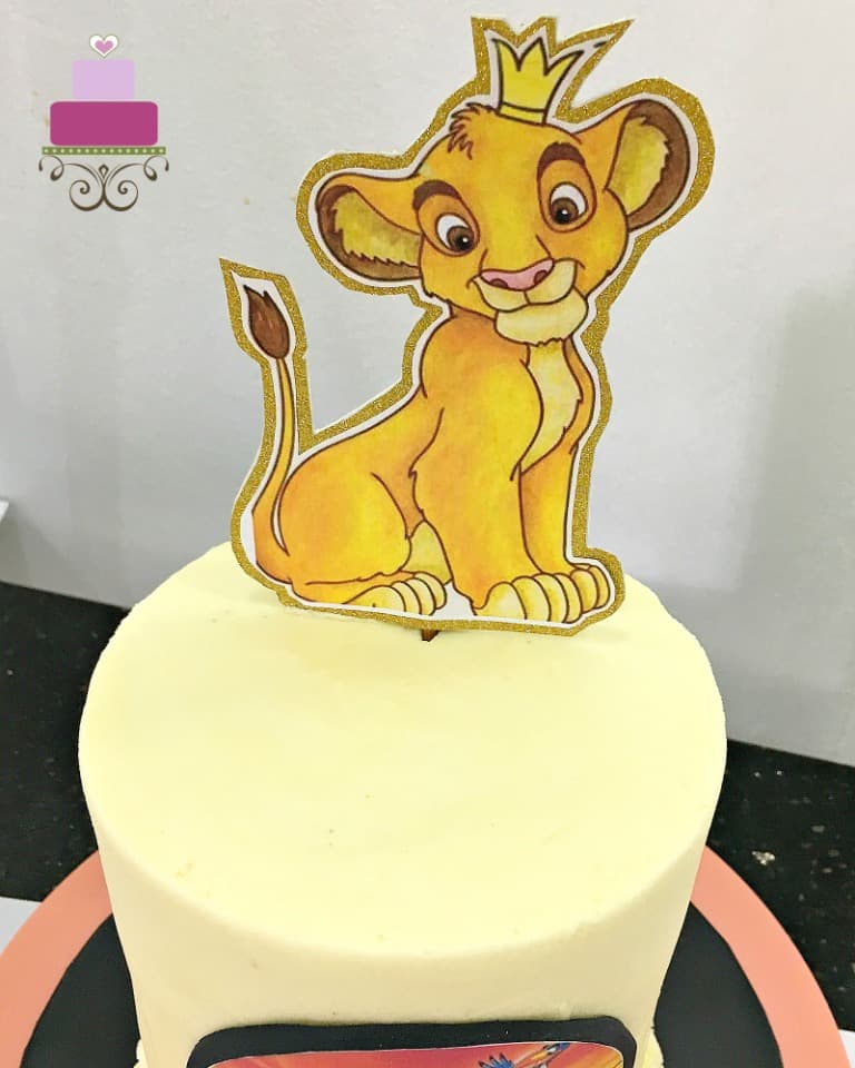 Simba cake topper on a cake