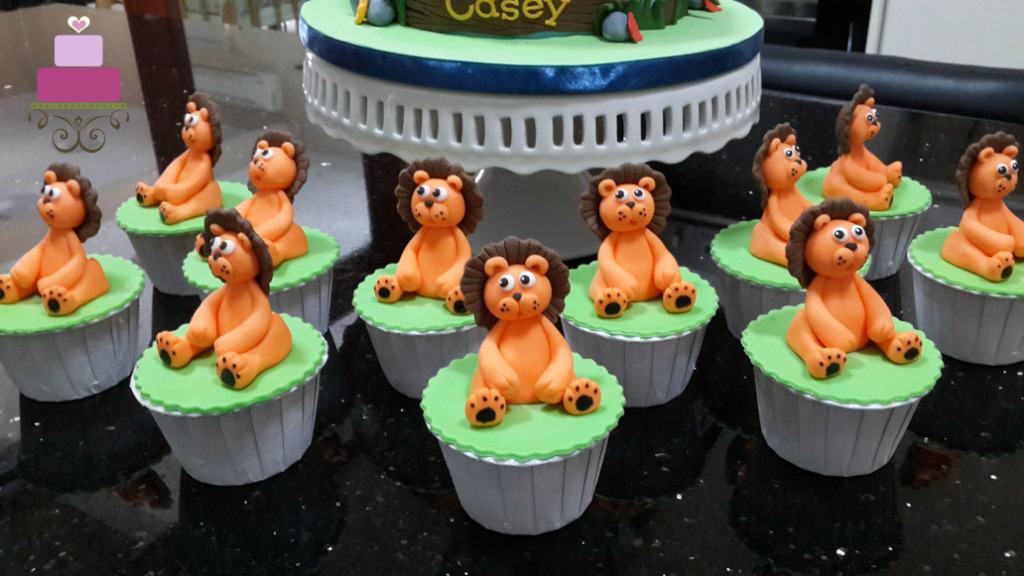 Green cupcakes with orange and brown lion toppers