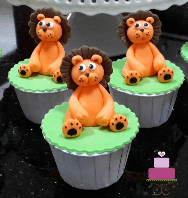 Green cupcakes with orange and brown lion toppers