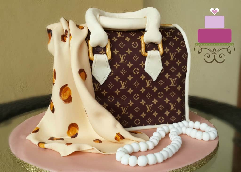 A Louis Vuitton inspired handbag cake with a leopard print scarf and edible pearl necklace