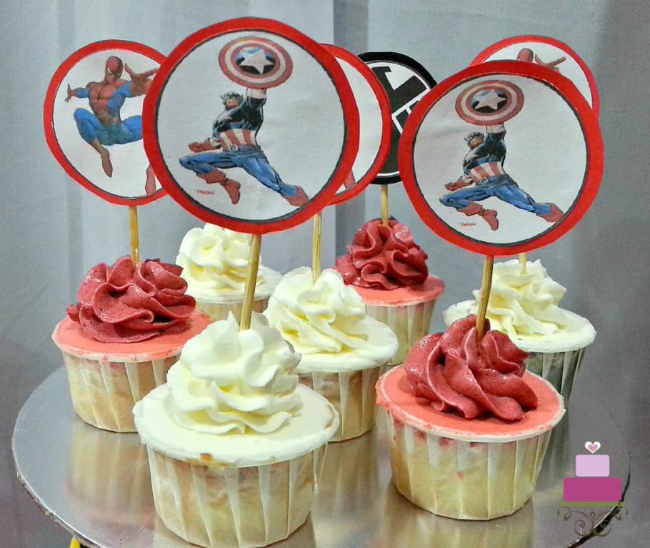Cupcakes with red and white buttercream swirls and Marvel Superheroes cupcake picks