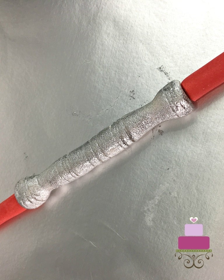 Silver and red fondant lightsaber