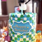 A double barrel Timmy Time cake with Timmy cake topper holding a balloon