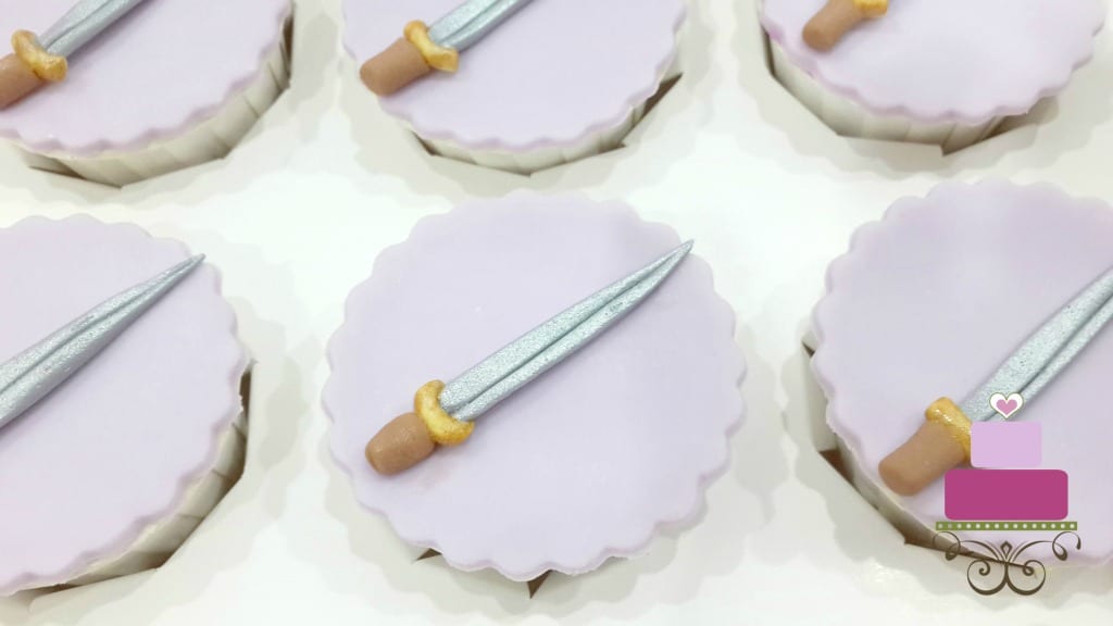 Purple cupcakes with sword toppers