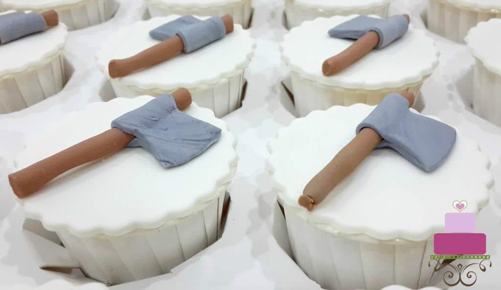 White cupcakes with fondant axe toppers