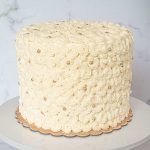 A round cake covered in buttercream rosettes.