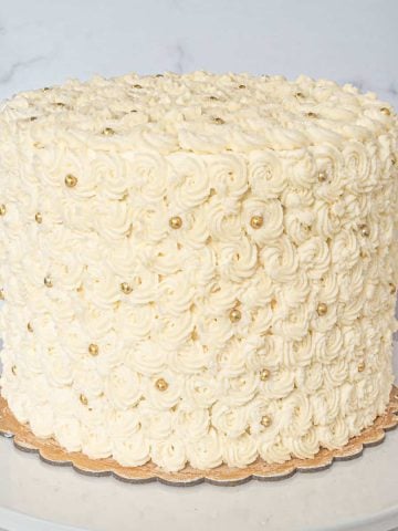 A round cake covered in buttercream rosettes.