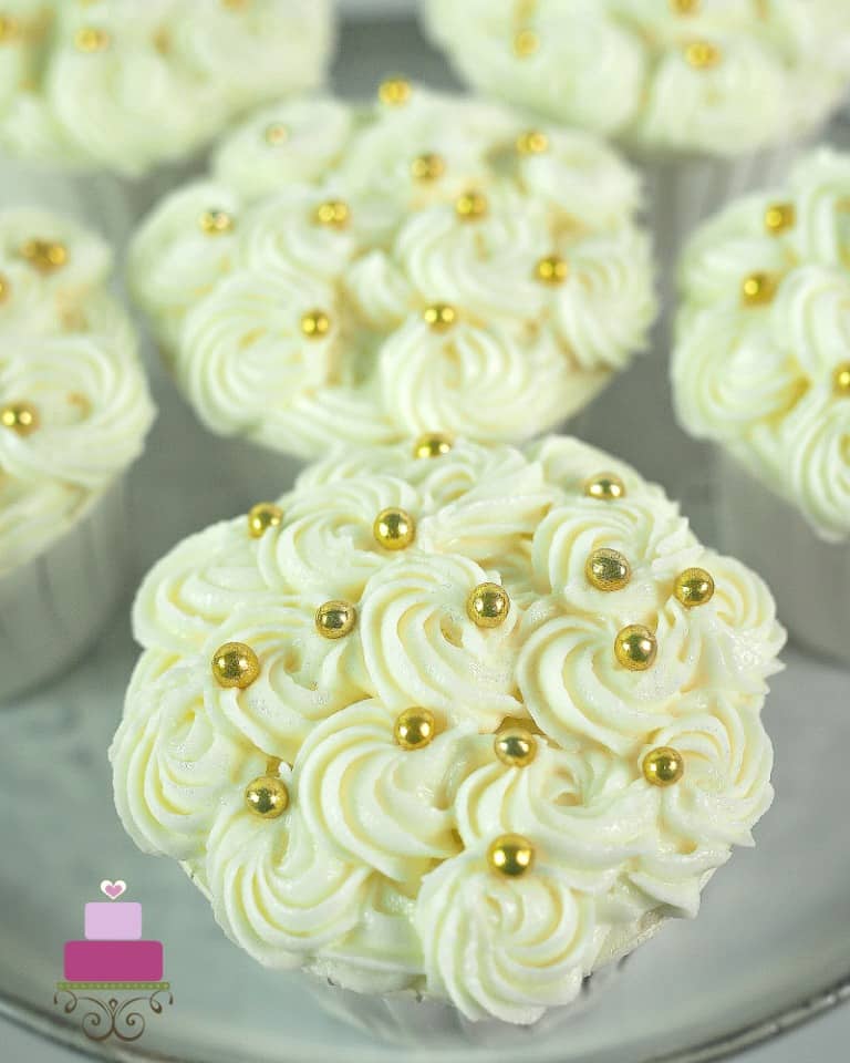 Cream cheese rosettes on a cupcake.