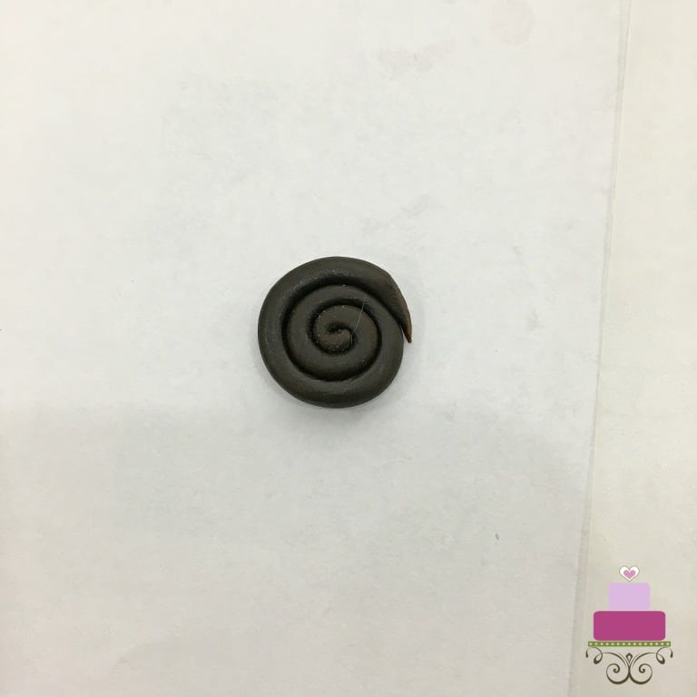 A round spiraled piece of brown fondant
