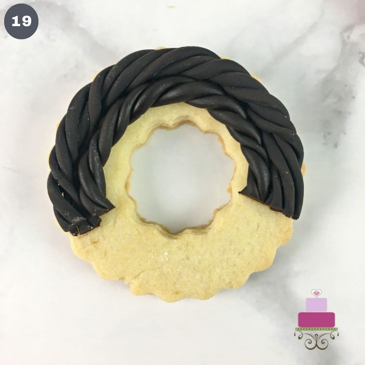 Brown fondant twigs on a round cookie.