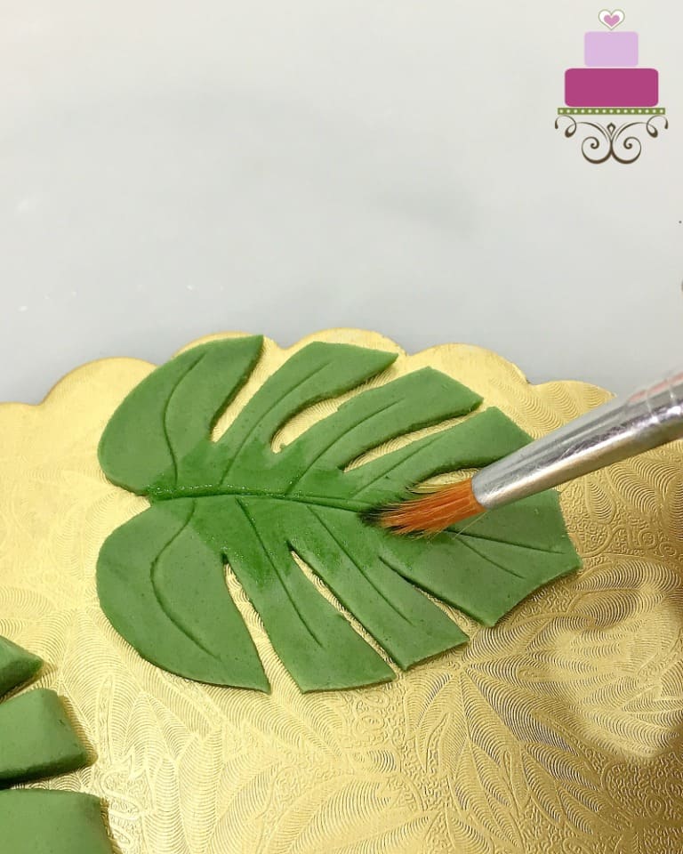 Painting a green fondant leaf