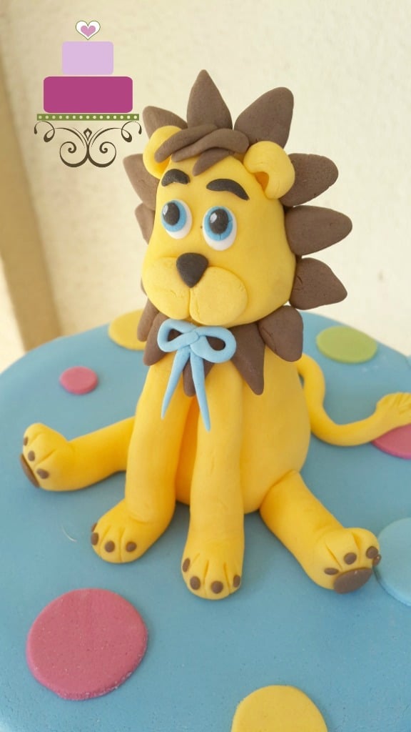 A yellow and brown lion cake topper.