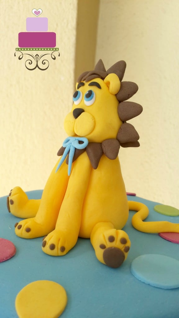 A yellow and brown lion cake topper.