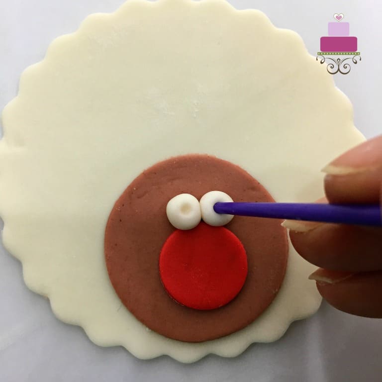 Forming the eyes on fondant with the back of a paintbrush
