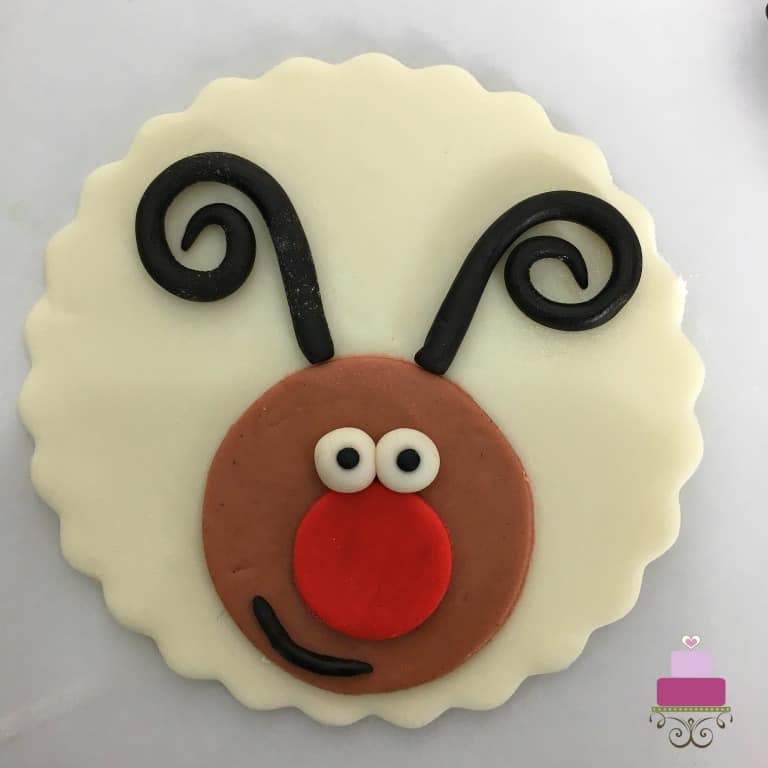 Cupcake topper with reindeer face.