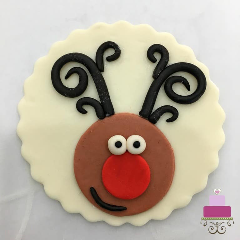 Cupcake topper with reindeer face.