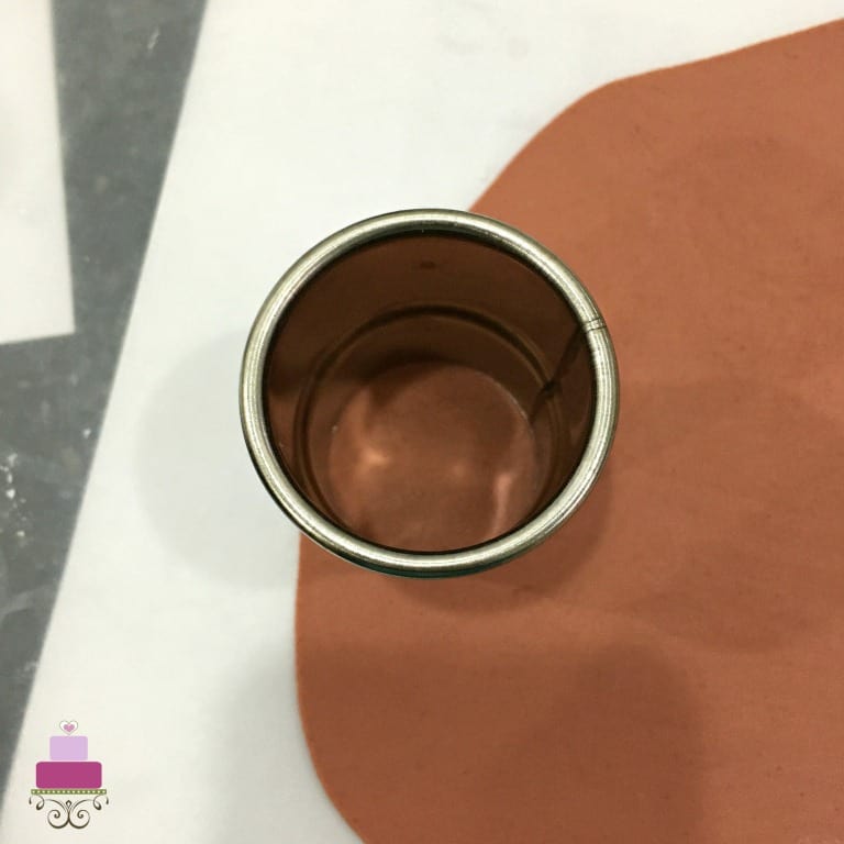 A round cutter on rolled brown fondant