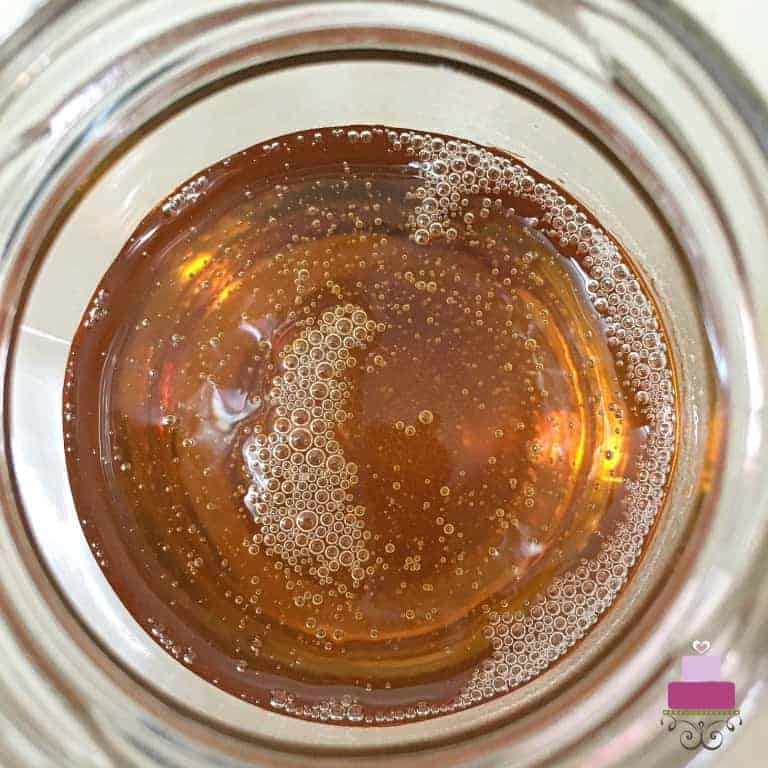 Top view on an open jar of golden syrup.