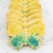 Butterfly shaped cookies stacked in a row.