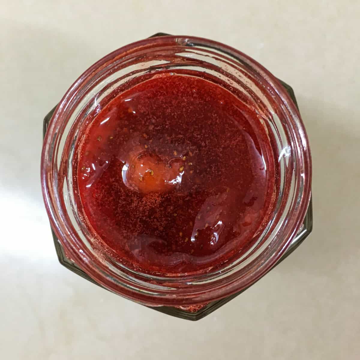 Top view of a jar of strawberry filling