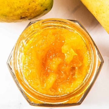 Top view of a jar of mango jam without the lid on
