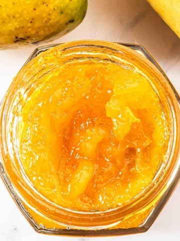 Top view of a jar of mango jam without the lid on.