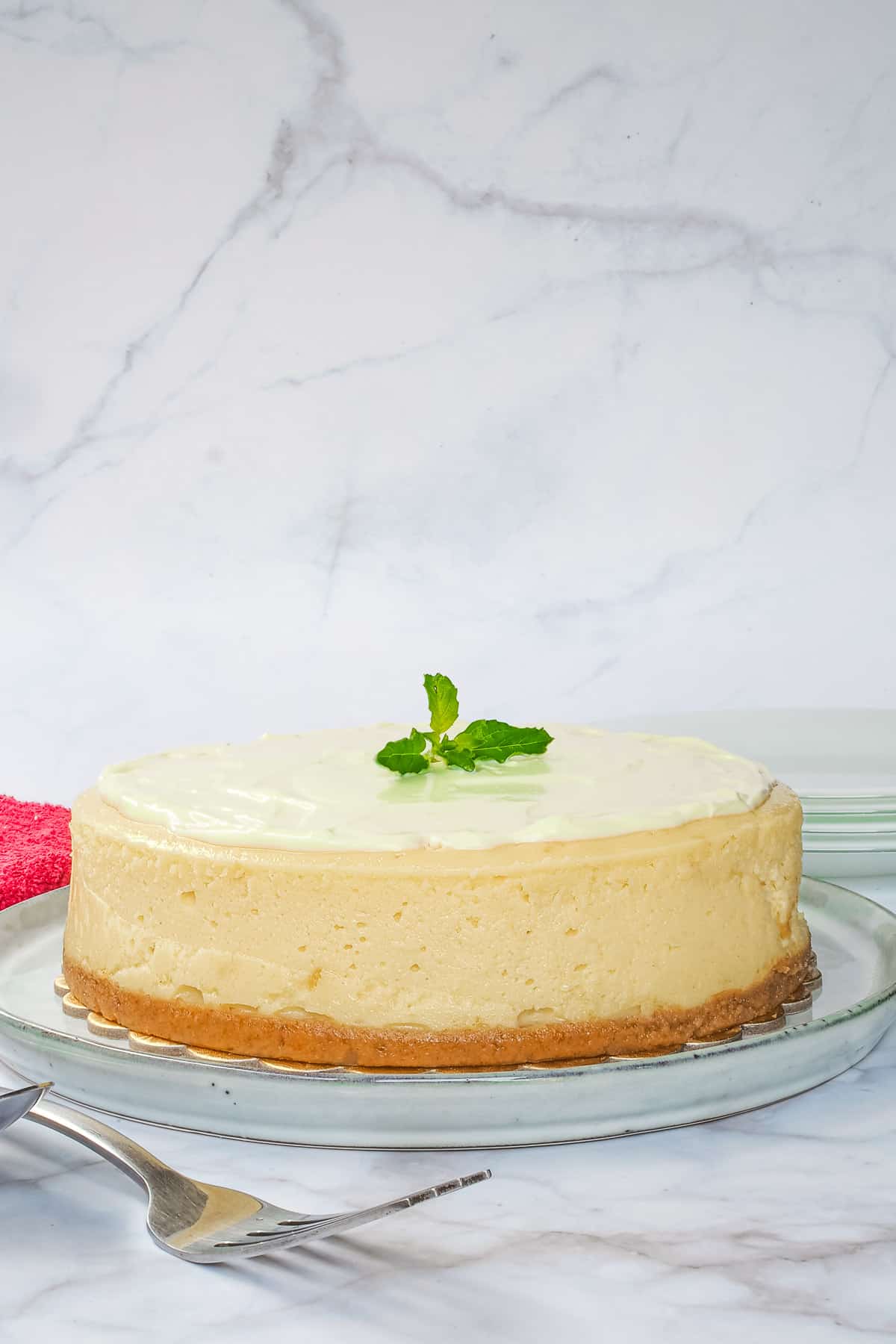 A round classic New York cheesecake with sour cream topping.