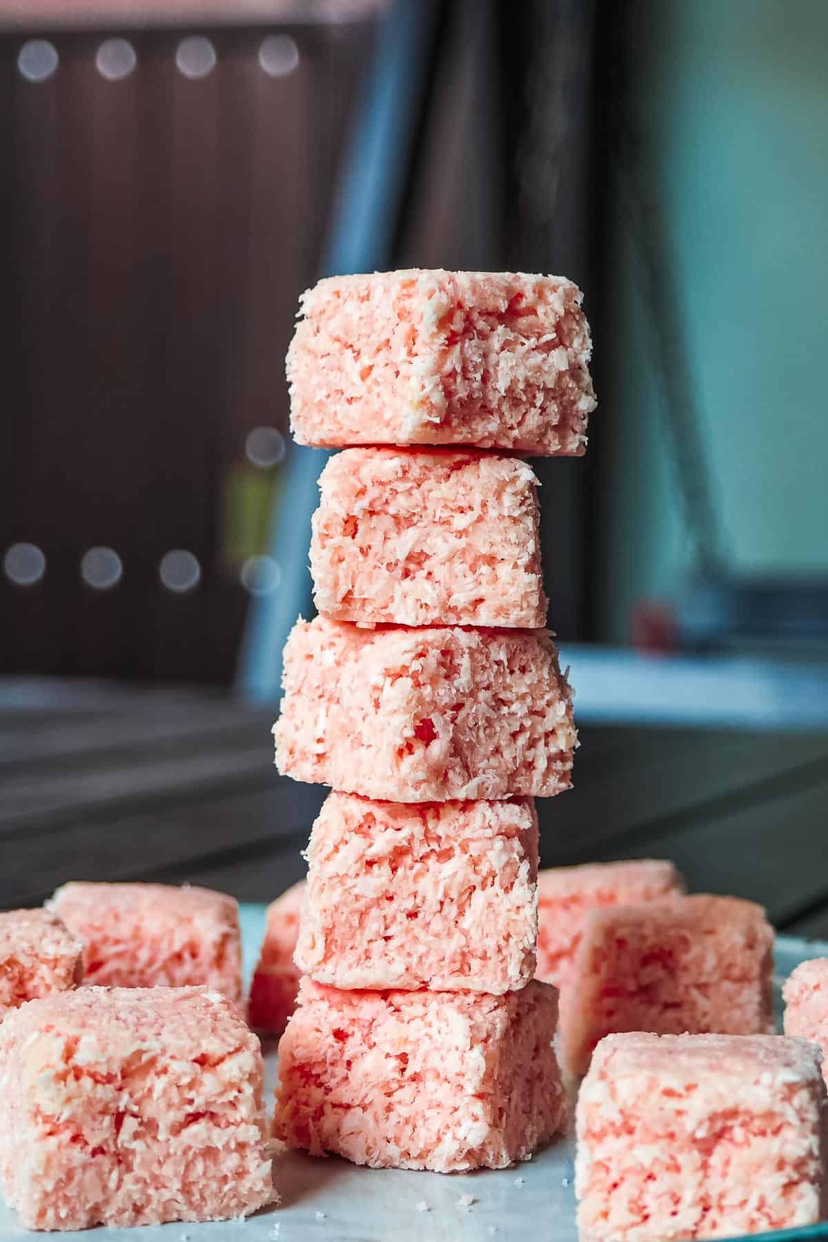 Pink coconut candy stacked on one another.