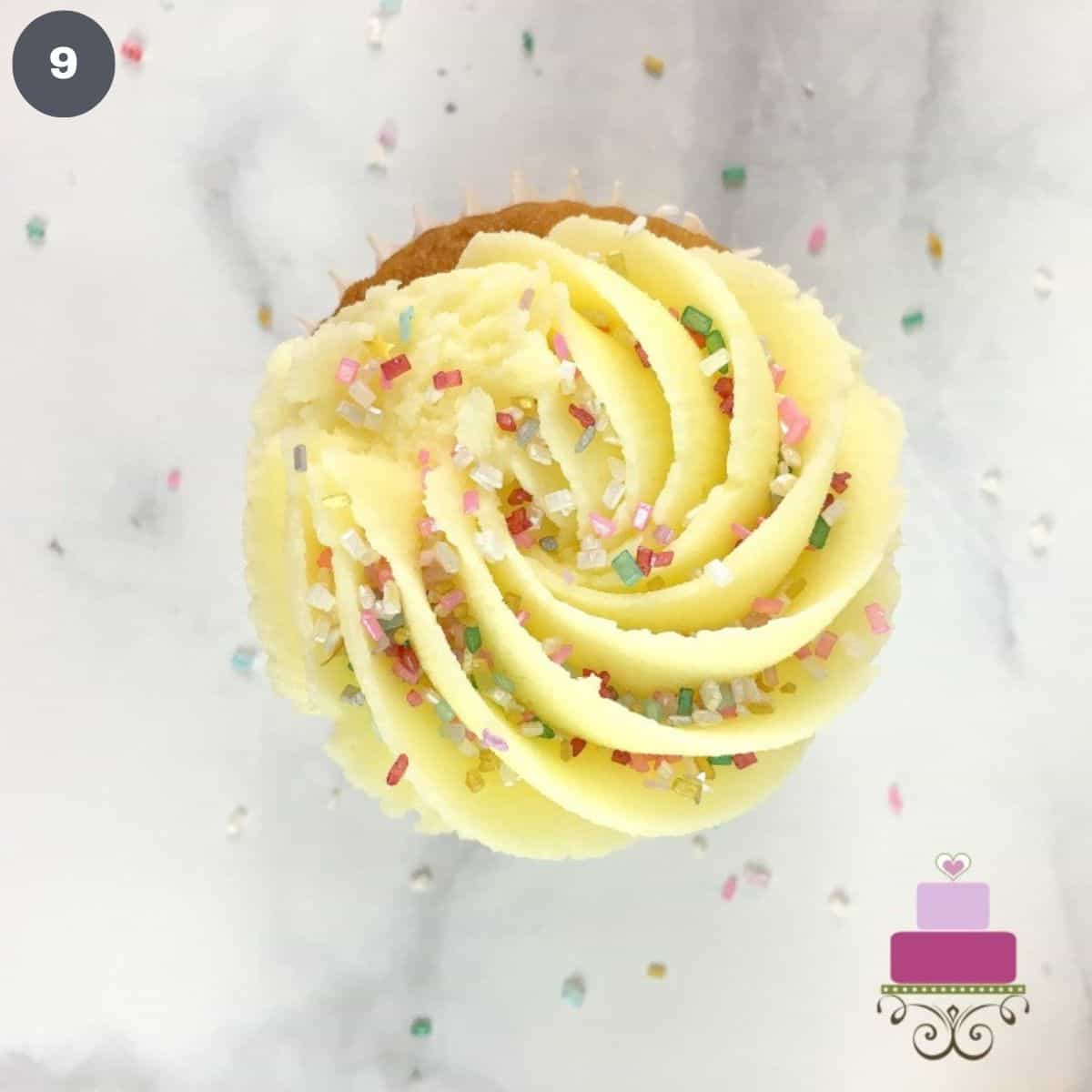 Cupcake topped with buttercream and sprinkles.