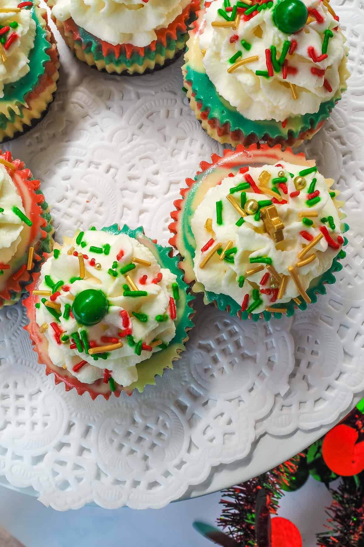 Mini marbled cupcakes topped with whipped cream and Christmas sprinkles.