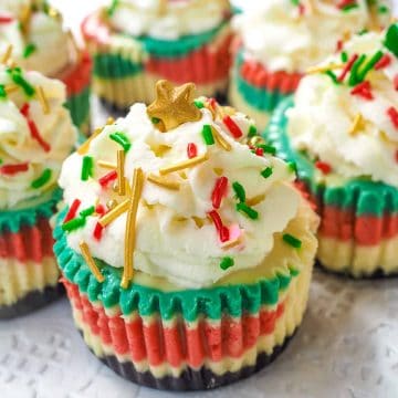 Mini marbled cupcakes topped with whipped cream and Christmas sprinkles