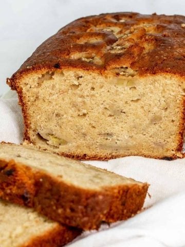 A loaf of banana pound cake with some slice cut.