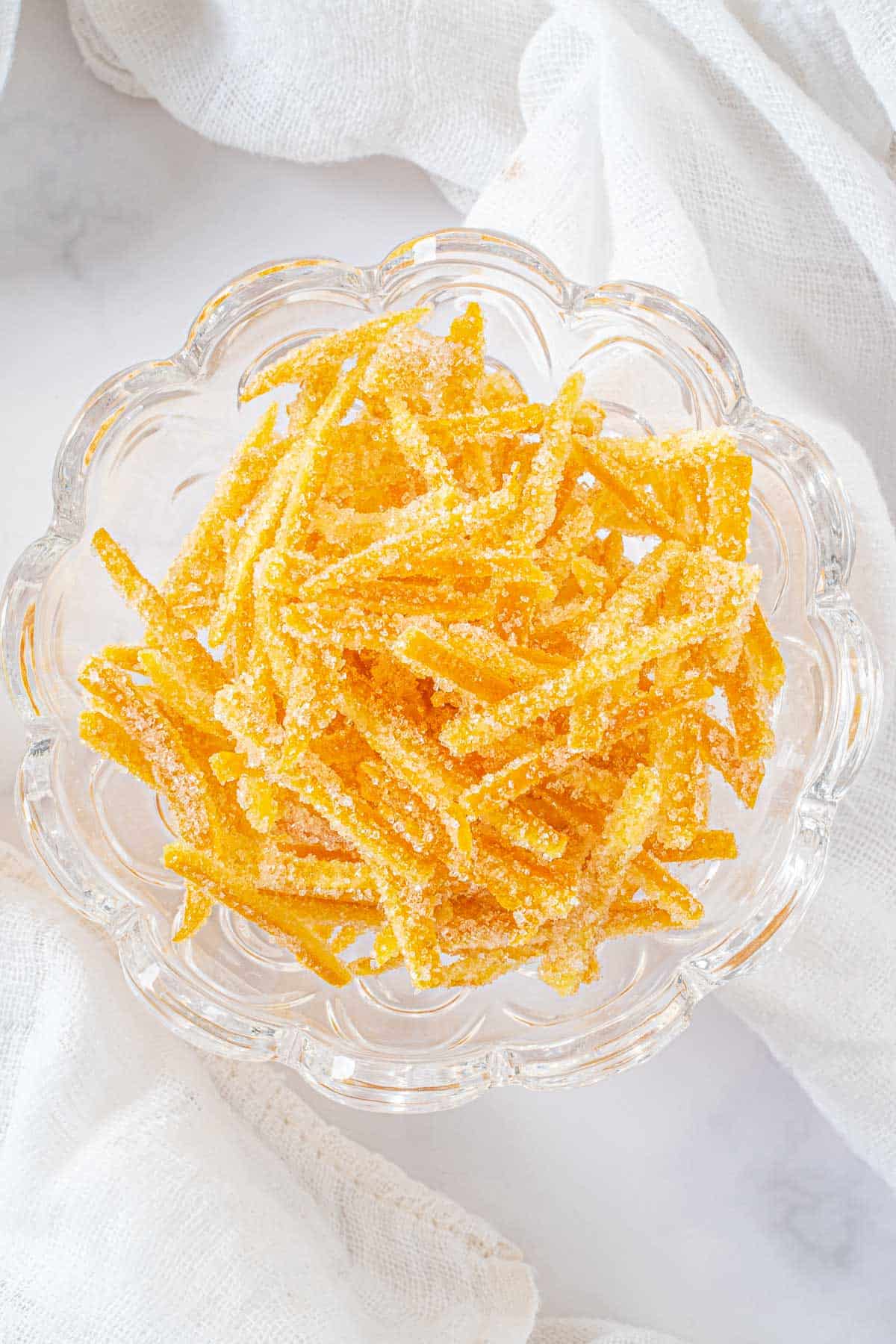A candy dish filled with orange peel candy.