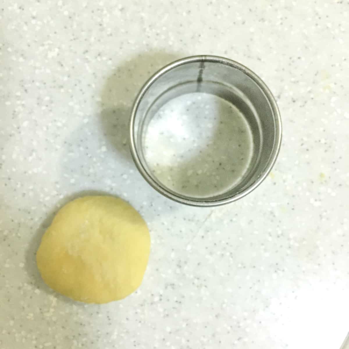 Dough outside a round cutter