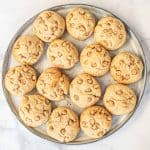 Butterscotch chips studded cookies on a grey plate