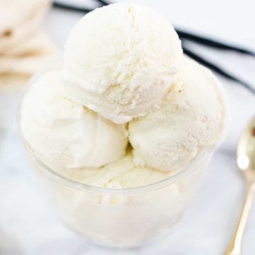 A glass bowl filled with vanilla ice cream scoops