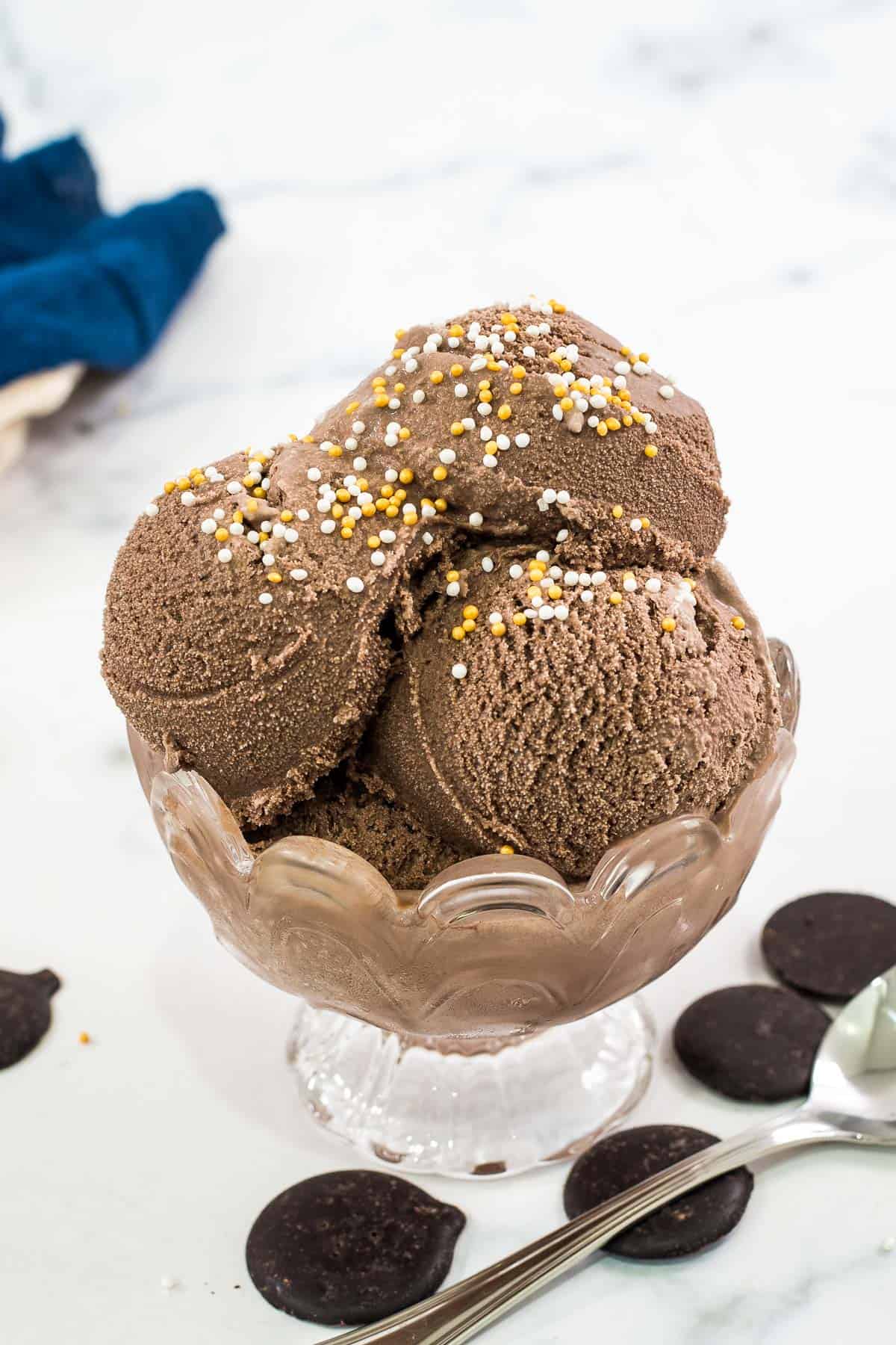 Scoops of chocolate ice cream topped with yellow and white sprinkles