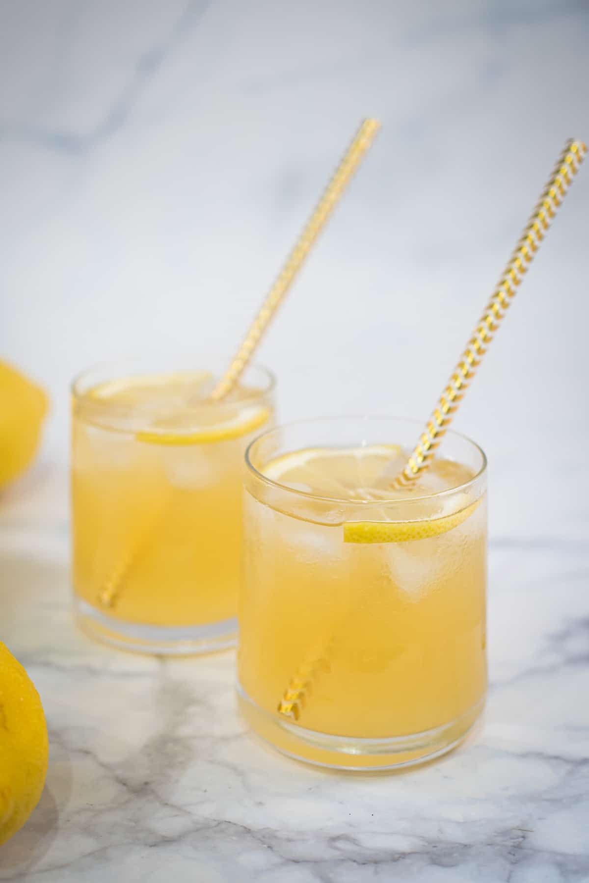 2 cups of lemonade with gold stripes straws.